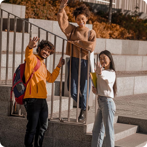 group of friends waving and smiling towards a camera